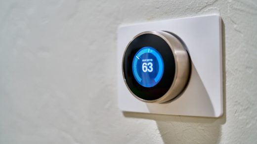 gray Nest thermostat displaying at 63